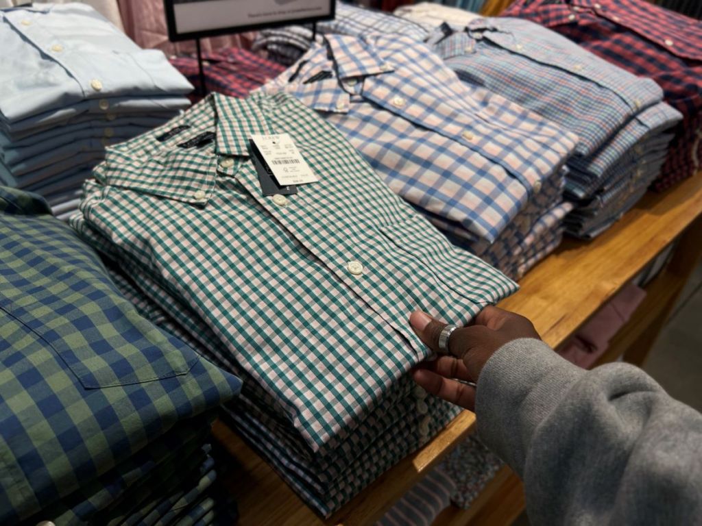 Row of folded shirts on a table at a store