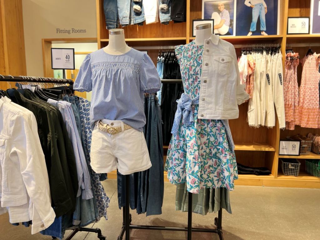 Display of mannequins with tees and shorts and one with a dress