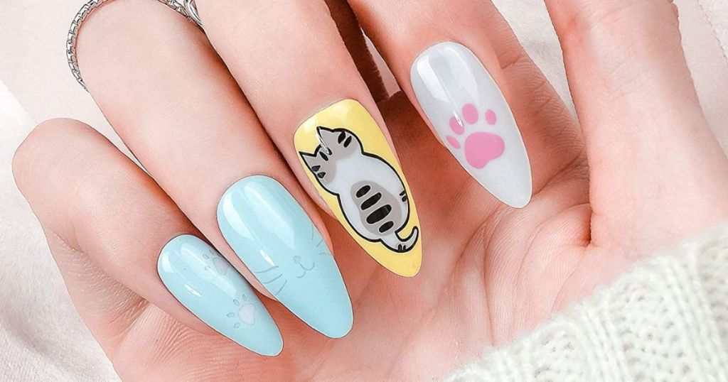 person wearing cat themed press on nails