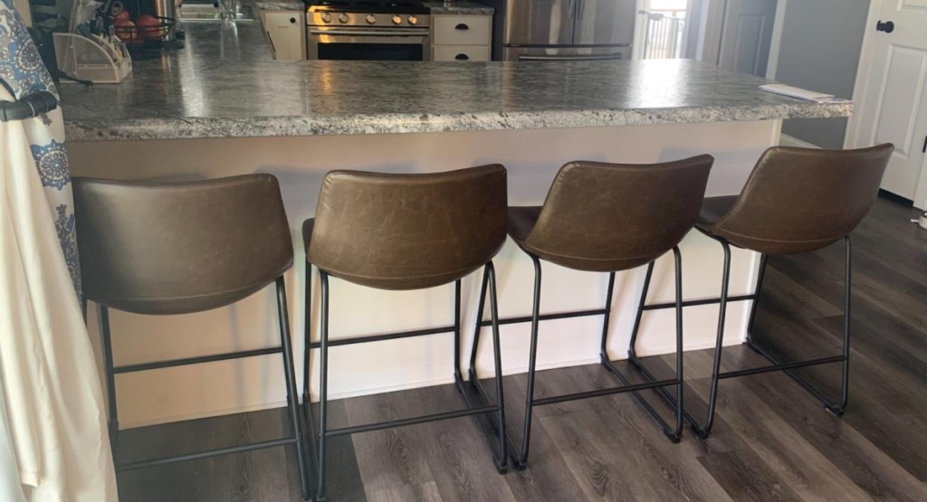 Kitchen with 4 brown barstools