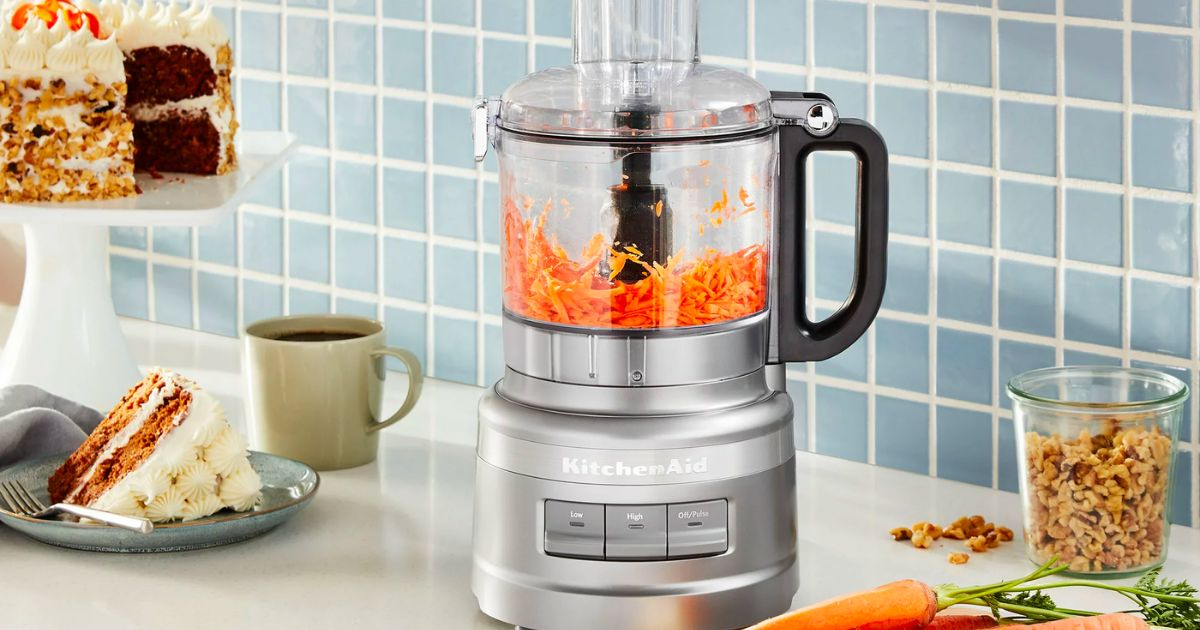 Food Processor with shredded carrots sitting on kitchen counter