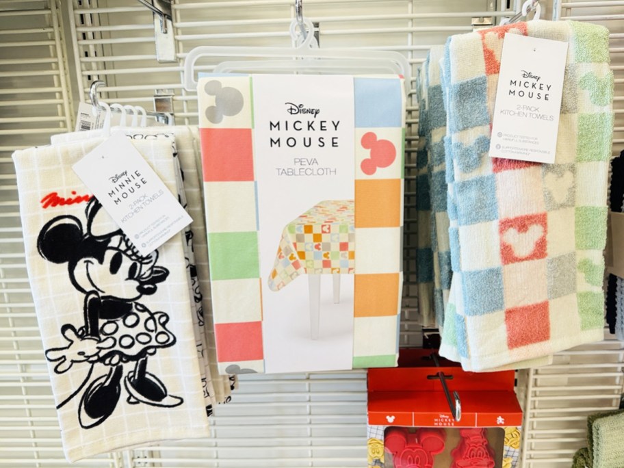 disney themed kitchen towels and tablecloth on store display