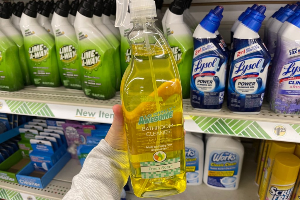 Woman holding up a bottle of LA Totally Awesome Bathroom Cleaner