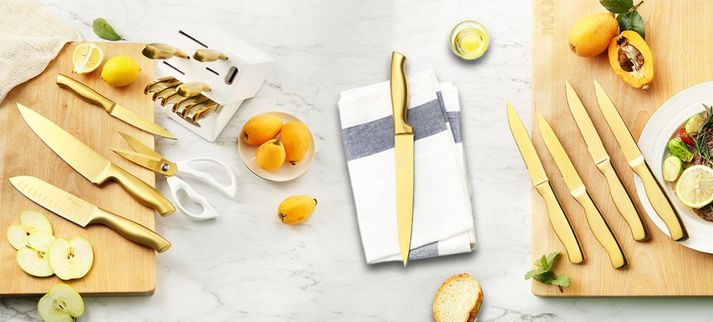 gold knife set on cutting boards and dish towels