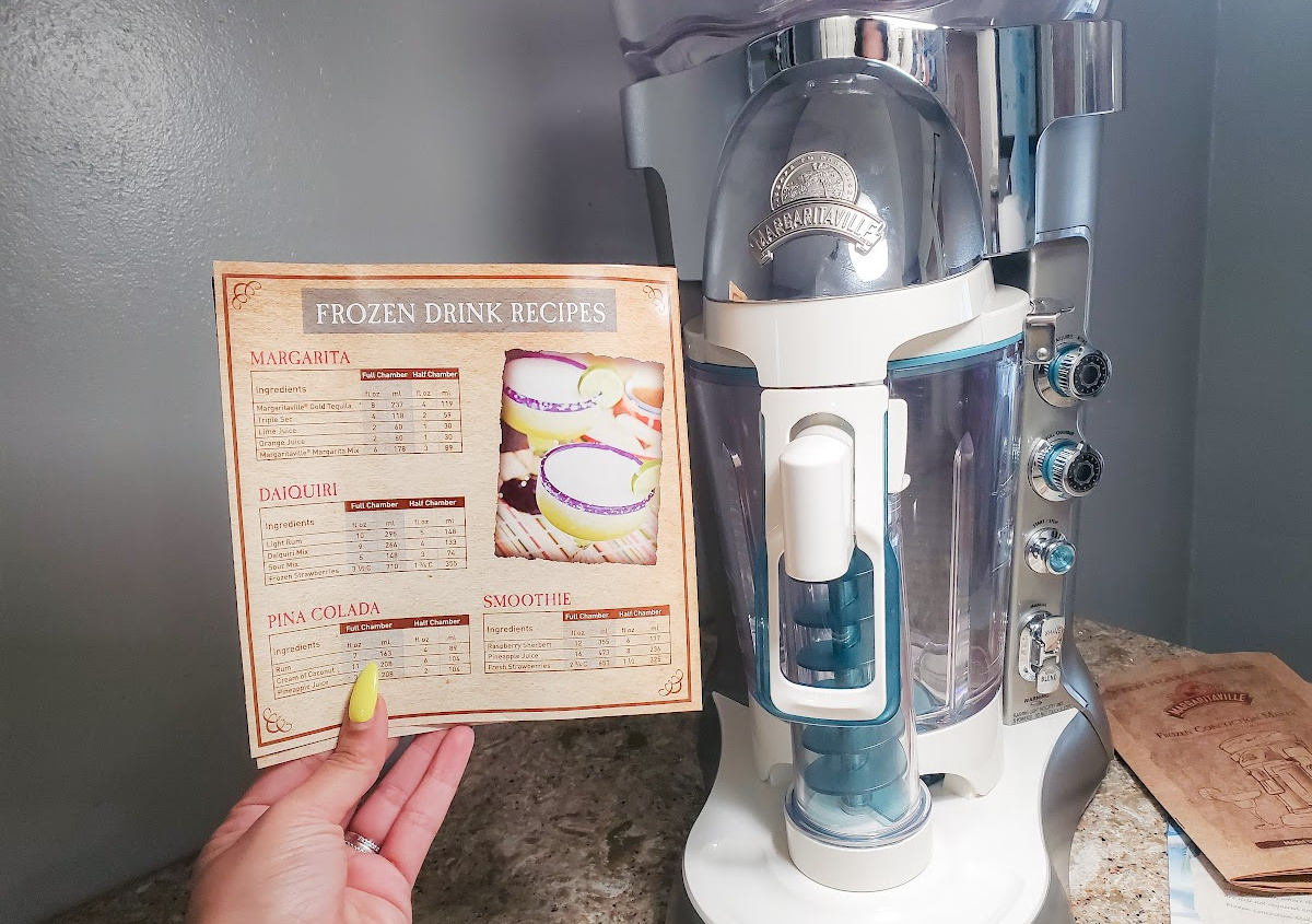 Woman holding a recipe card for her Margaritaville Machine