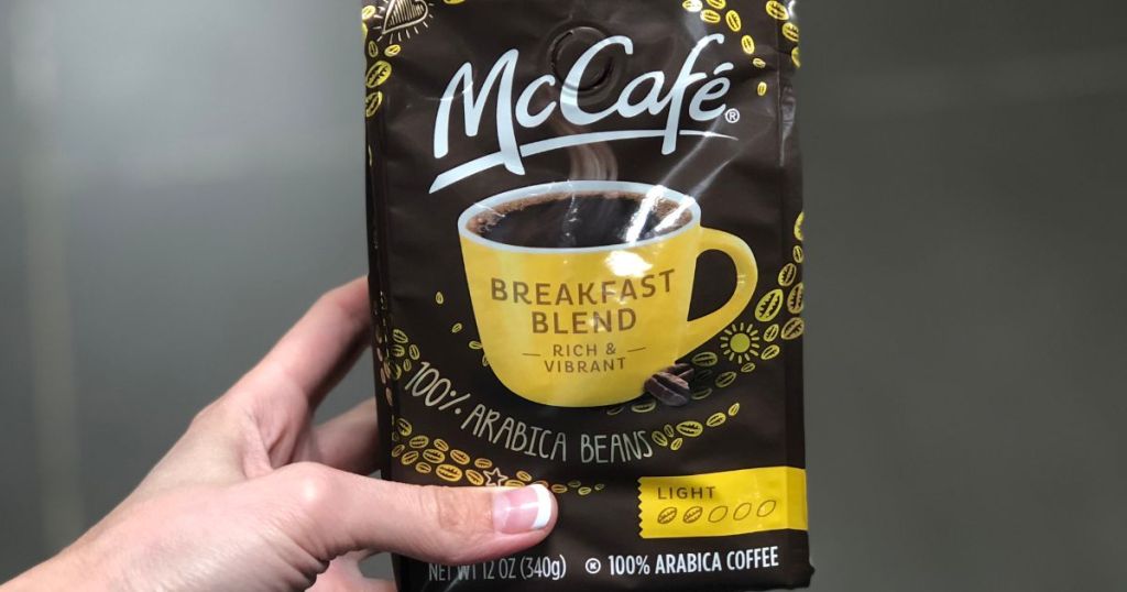 Hand holding a bag of McCafe breakfast blend coffee