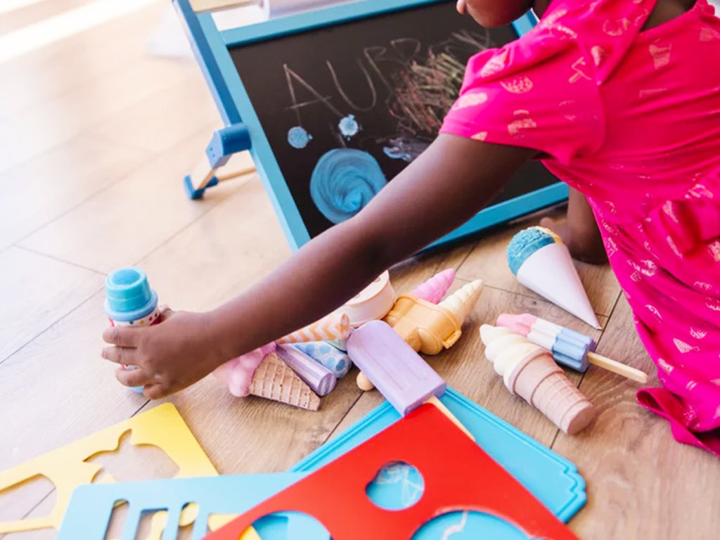 girl playing with Melissa & Doug Ice Cream Shop Chalk Set