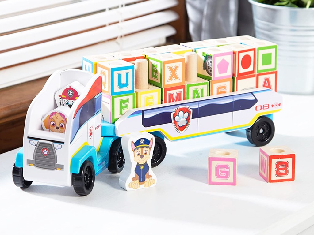 Melissa & Doug PAW Patrol Wooden ABC Block Truck on a white shelf