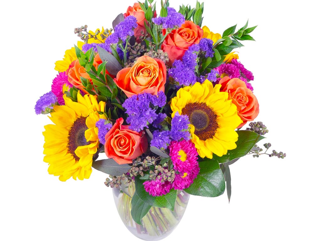 flower bouquet with sunflowers and roses in a clear vase