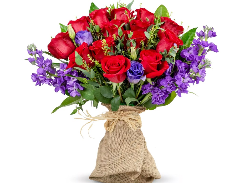red roses with purple flowers in a burlap wrap