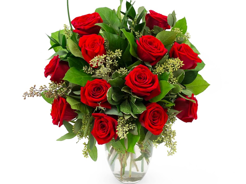 red roses and greenery in vase
