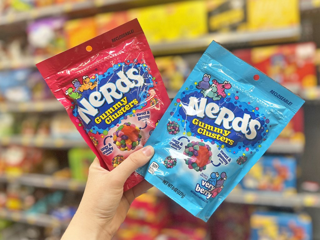 hand holding up two bags of nerds gummy clusters