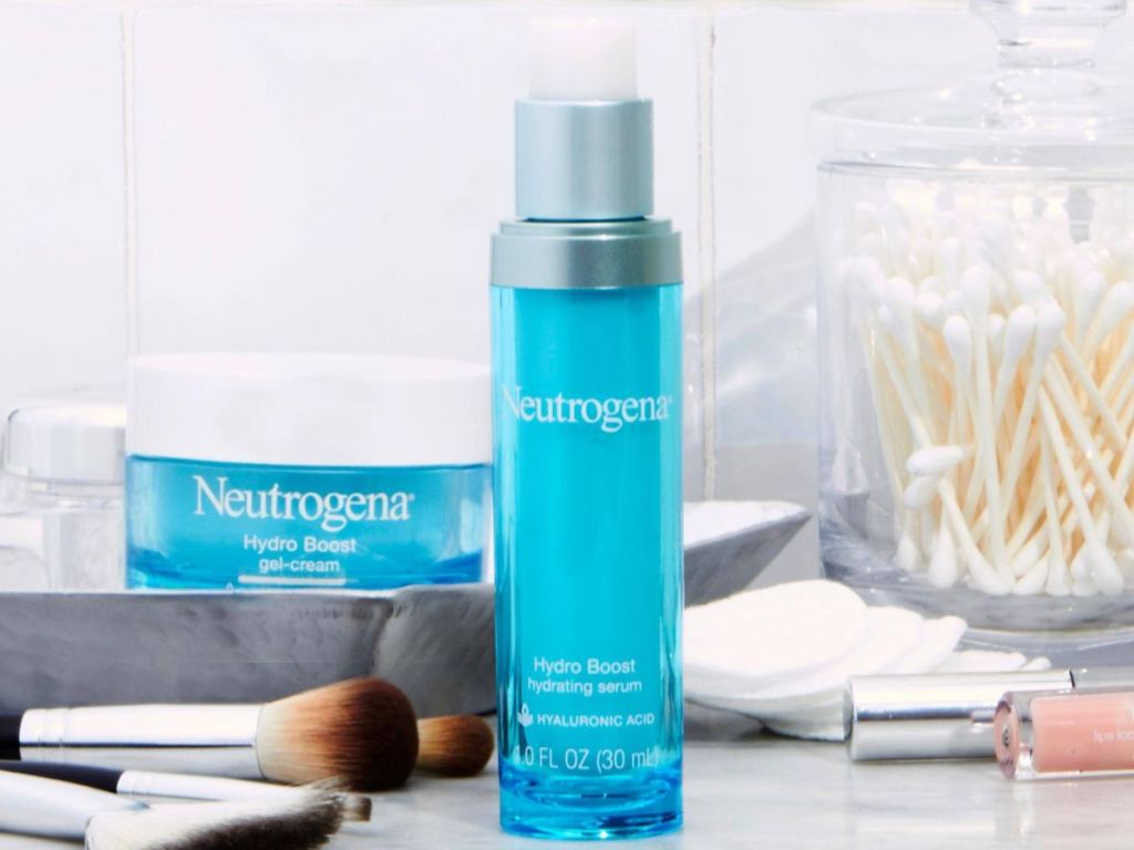 Bottle of Neutrogena Hydro Boost Serum with other beauty products around it