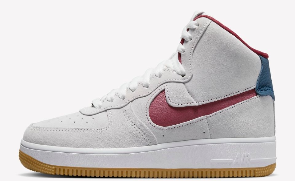 White Nike high top shoes with a red logo and tan sole