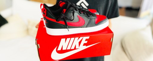 pair of black and red nike sneakers on top of red shoe box