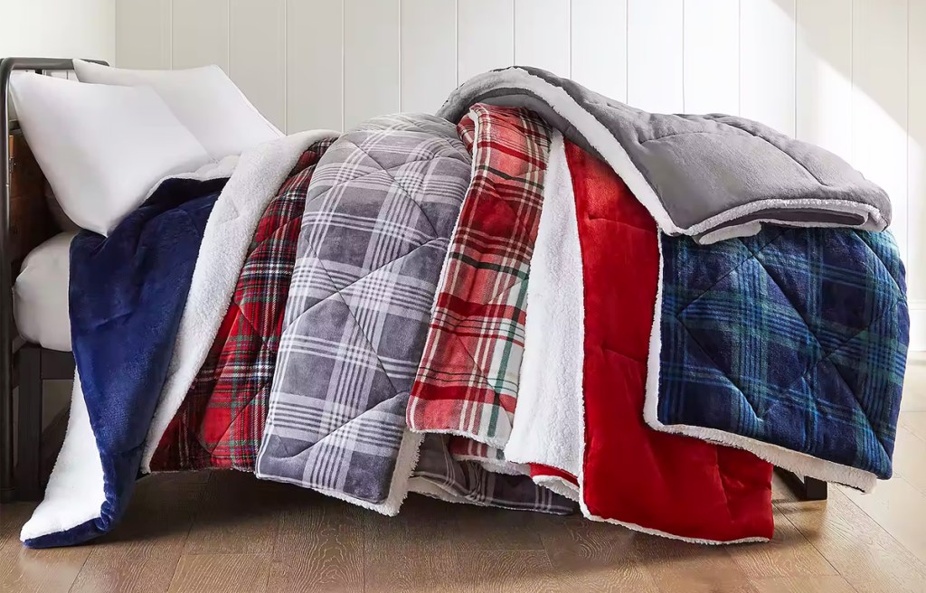 multiple reversible comforters on bed
