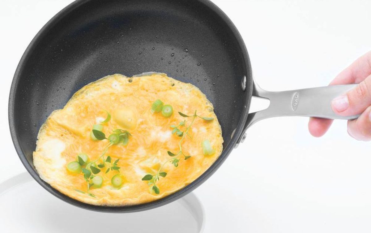 Eggs sliding out of an OXO frying pan onto a plate