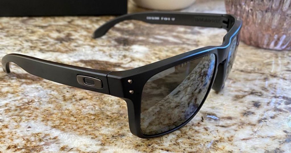 black frame Oakley sunglasses on marble counter