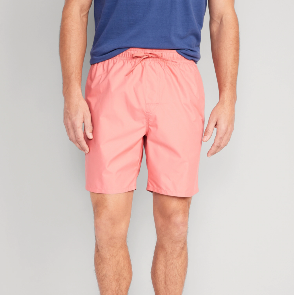 Man wearing a pair of mens swim trunks from old navy