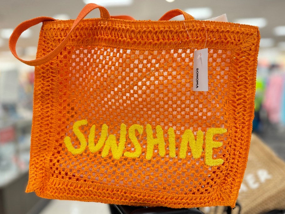 Orange sunshine tote bag inside of kohls shopping cart