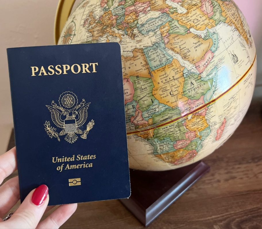 A passport next to a globe