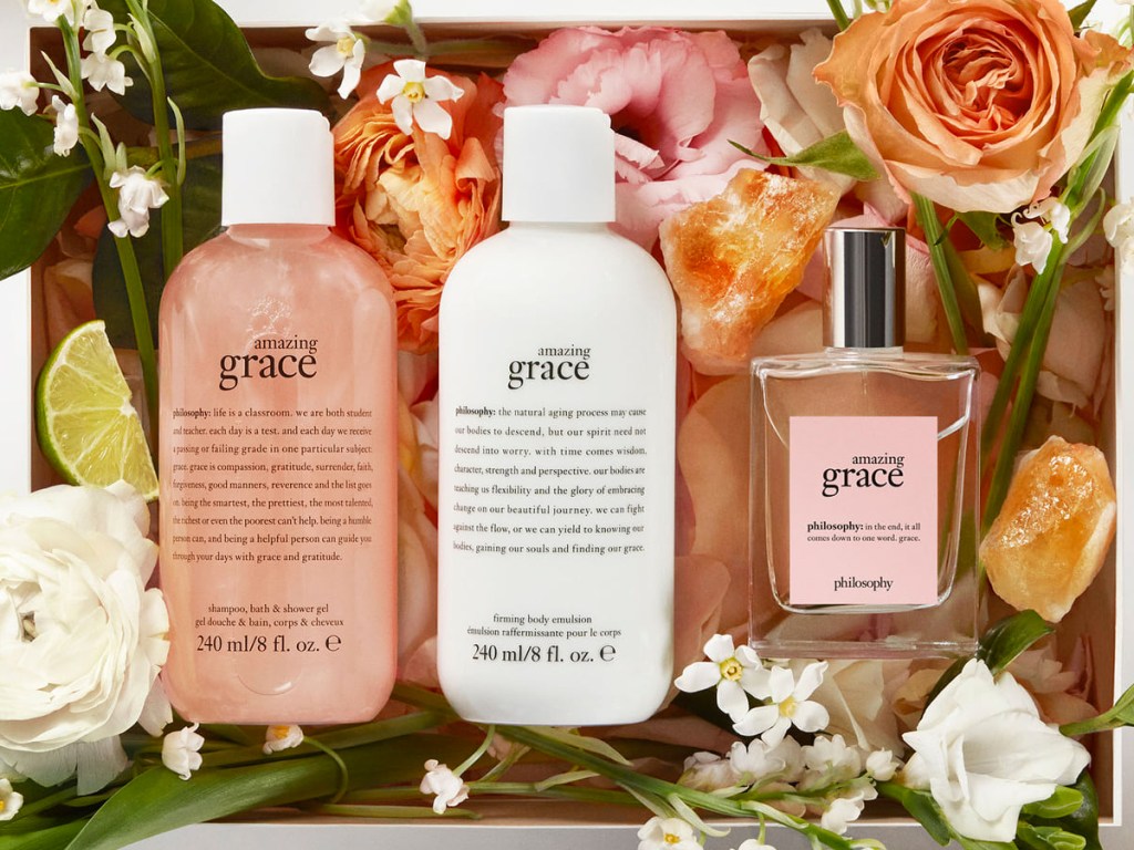 amazing grace lotion, shower gel, and perfume in a gift box with flowers