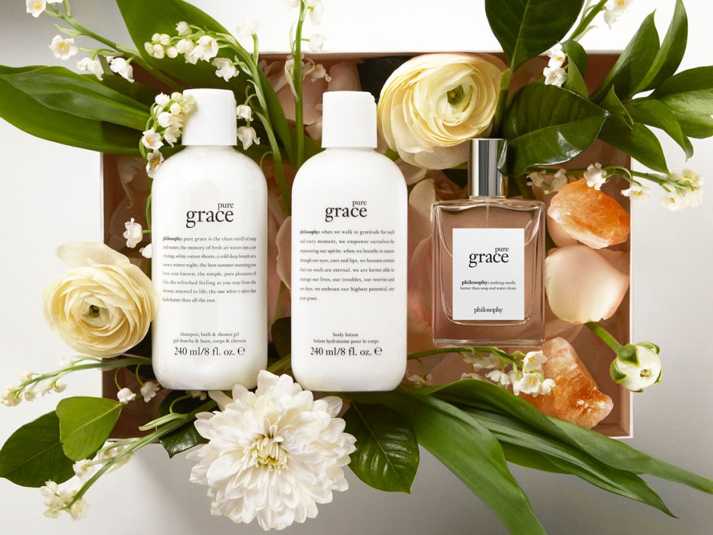 pure grace lotion, shower gel, and perfume in a gift box with flowers