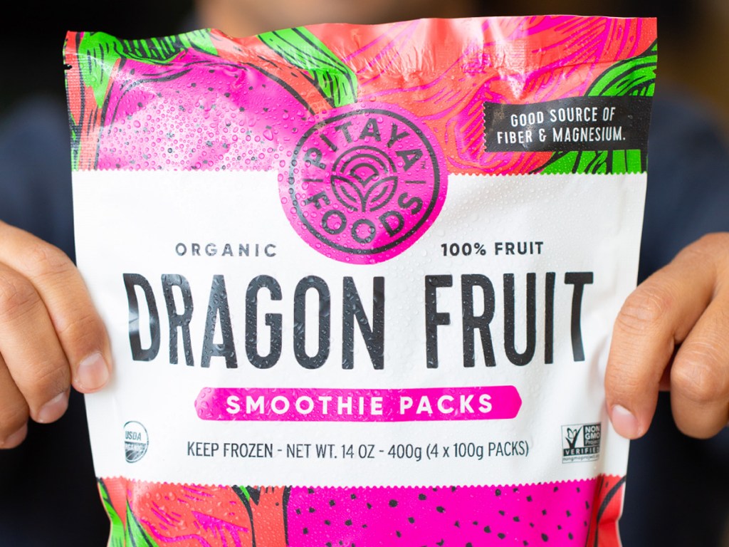 hands holding a package of organic dragon fruit smoothie packs