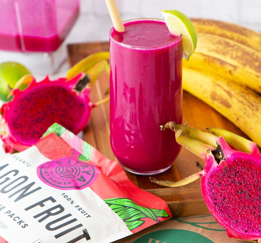 pink dragon fruit smoothie with cut dragon fruits around it