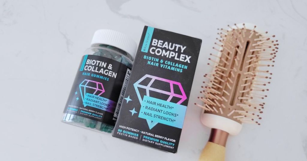 bottle of Raw Science Beuaty Complex Biotin & Collagen hair vitamins and package next to hair brush