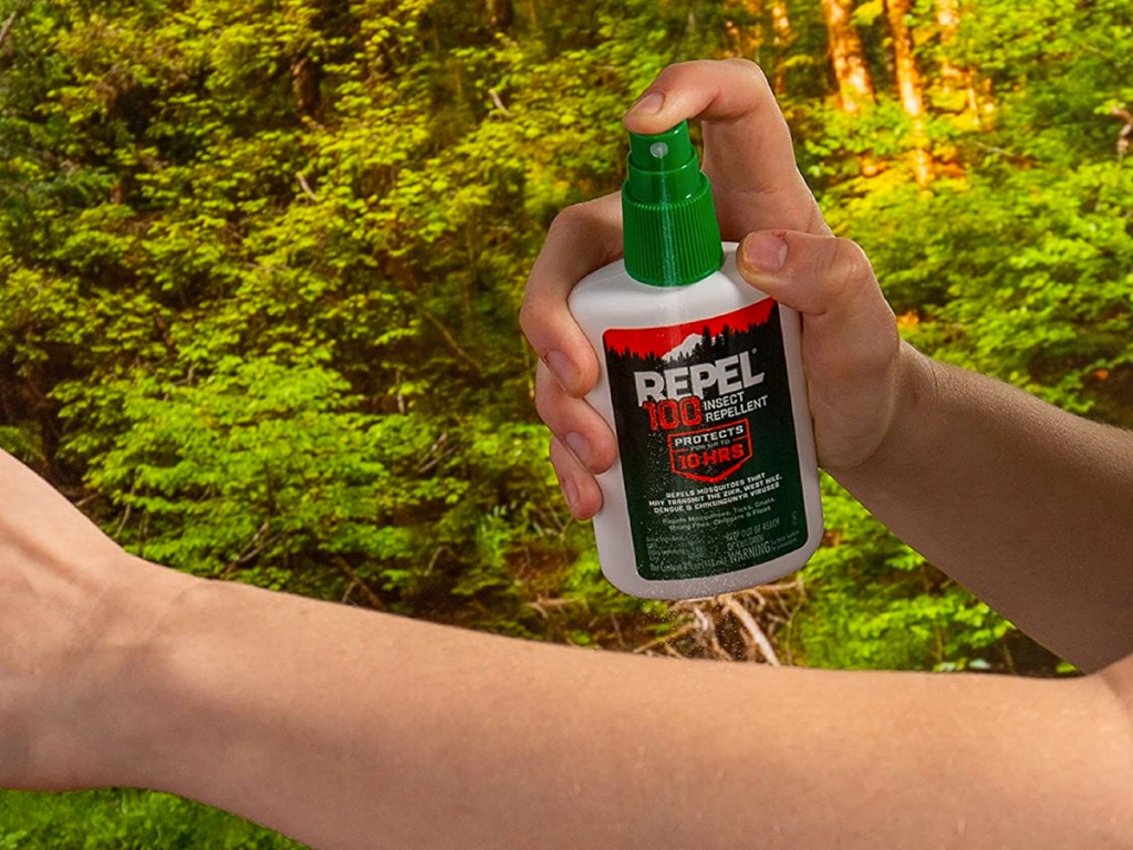 person applying Repel 100 Insect Repellent Spray to arm