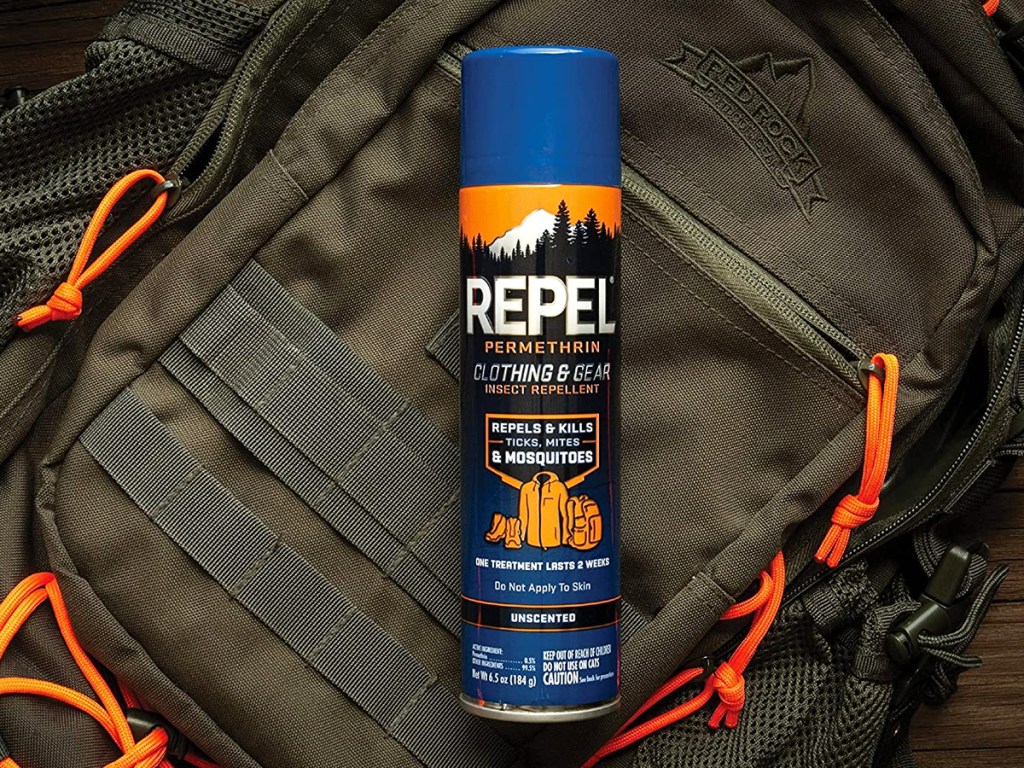 bottle of Repel Permethrin Clothing & Gear Insect Repellent on top of backpack