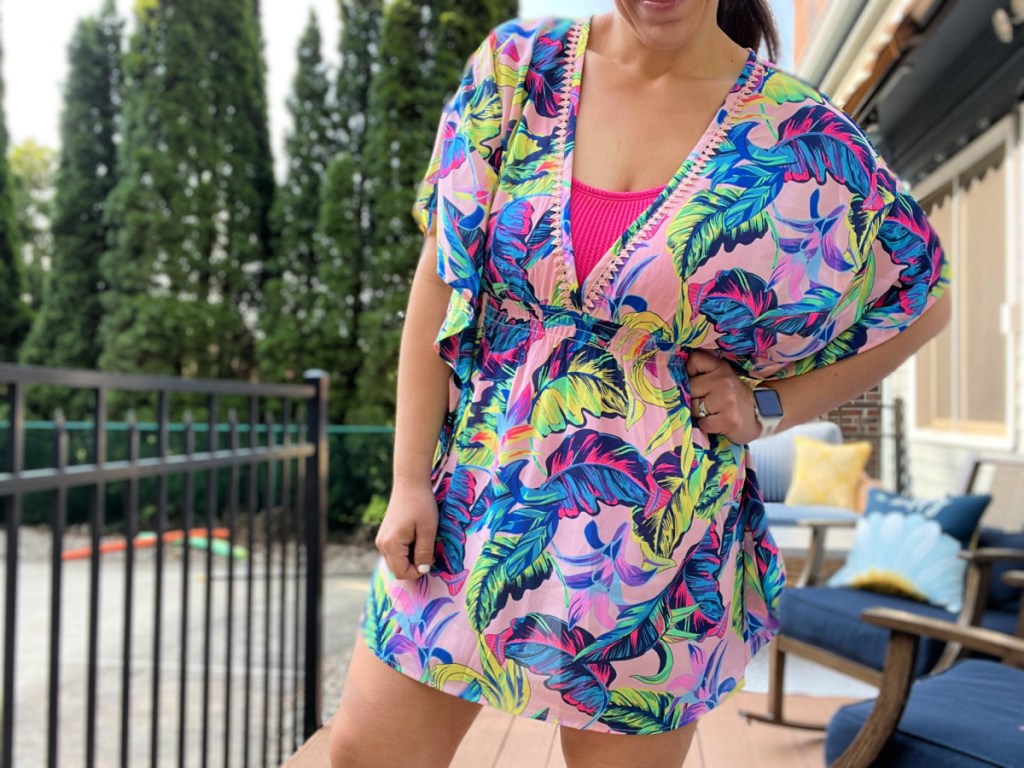 woman standing near a pool wearing the retro floral No Boundaries swim cover up from Walmart
