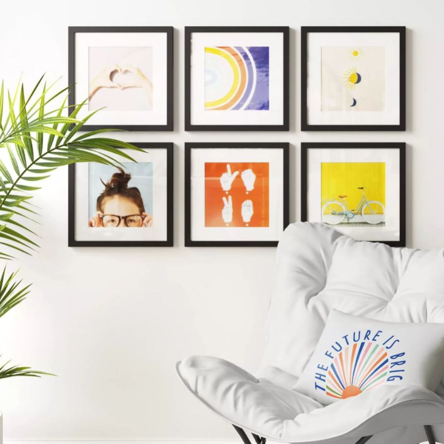 6 black picture frames hanging on a wall in a 2 x 3 layout