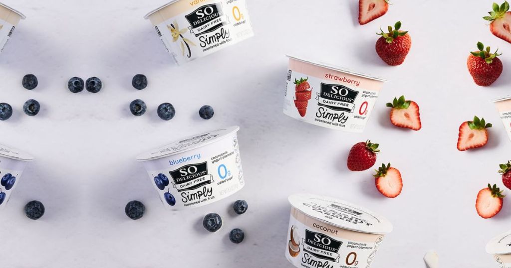 So Delicious Simply Yogurt next to strawberries, blueberrues and coconut