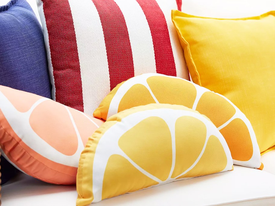 pink, orange, and yellow citrus slice outdoor throw pillows on patio couch