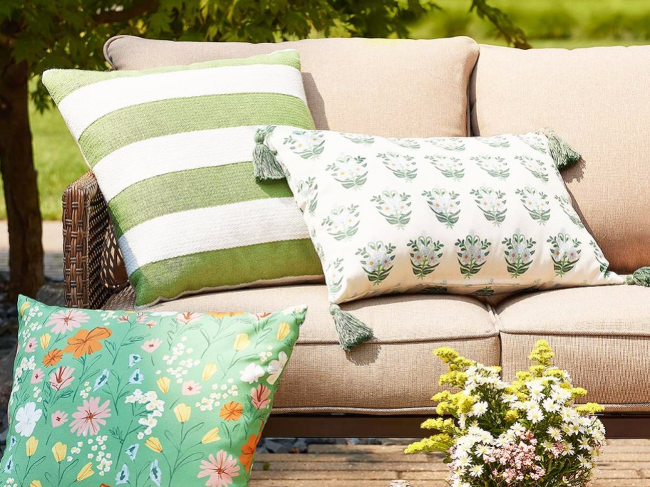 green outdoor throw pillows on outdoor couch with beige cushions
