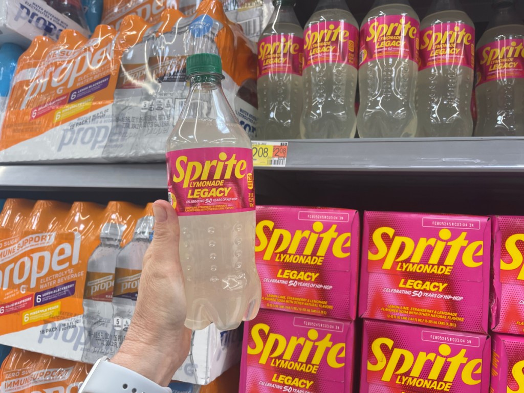 Hand grabbing a bottle of Sprite Lymonade Legacy from the store shelf