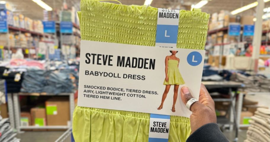 Hand holding up a Steve Madden Babydoll dress