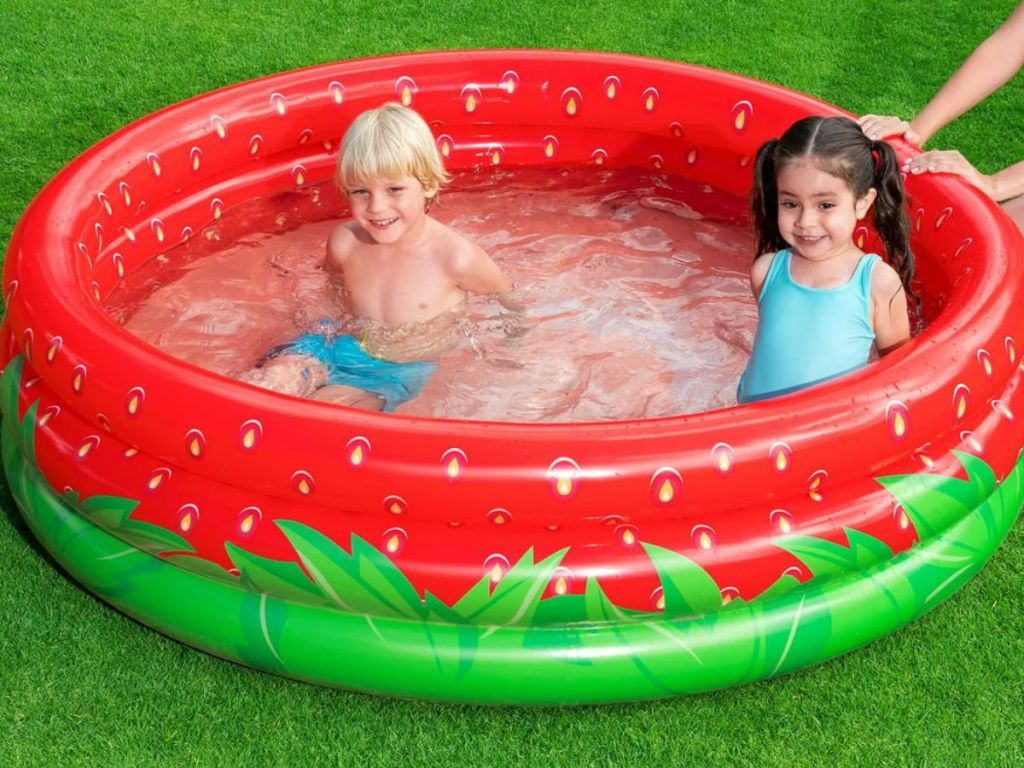 Two kids in a strawberry kiddie pool