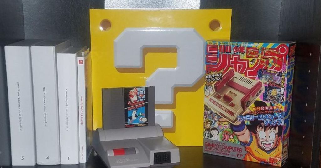 Shelf with a video game console, books and a game cartridge