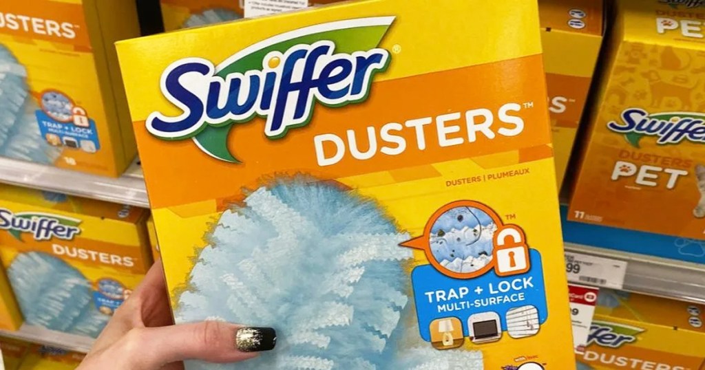 hand holding a yellow box of Swiffer Dusters