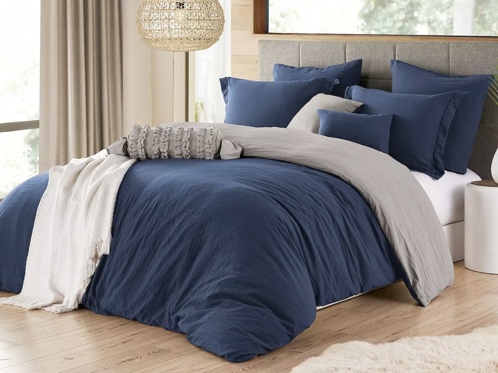 navy blue duvet set and pillows on bed