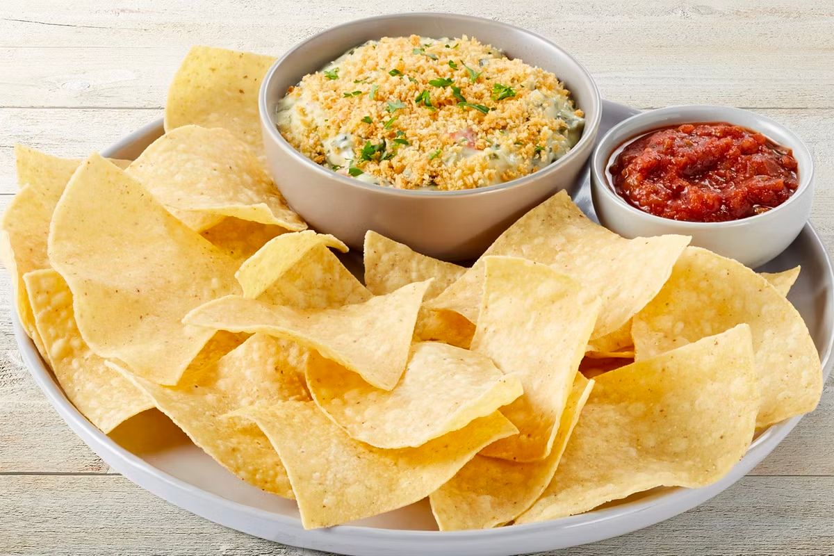 TGI fridays chips n salsa and a bowl of artichoke dip