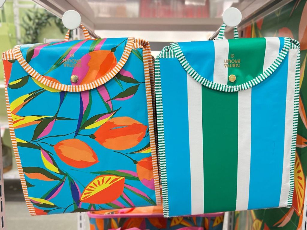 Two styles of Tabitha Brown Packable Tote Bags hanging on racks at Target
