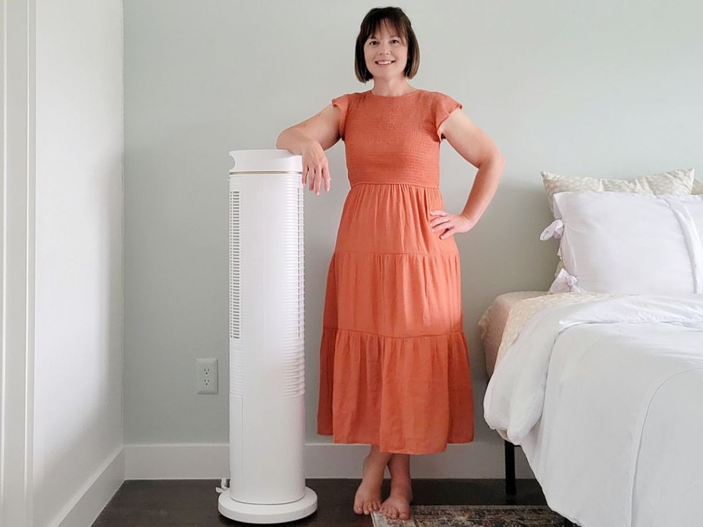 woman standing next to a Taotronics Tower Fan in a bedroom