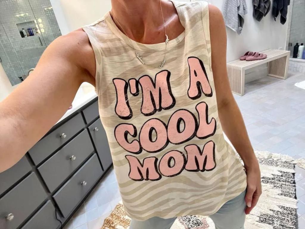 woman taking a selfie in a "cool mom" tank top