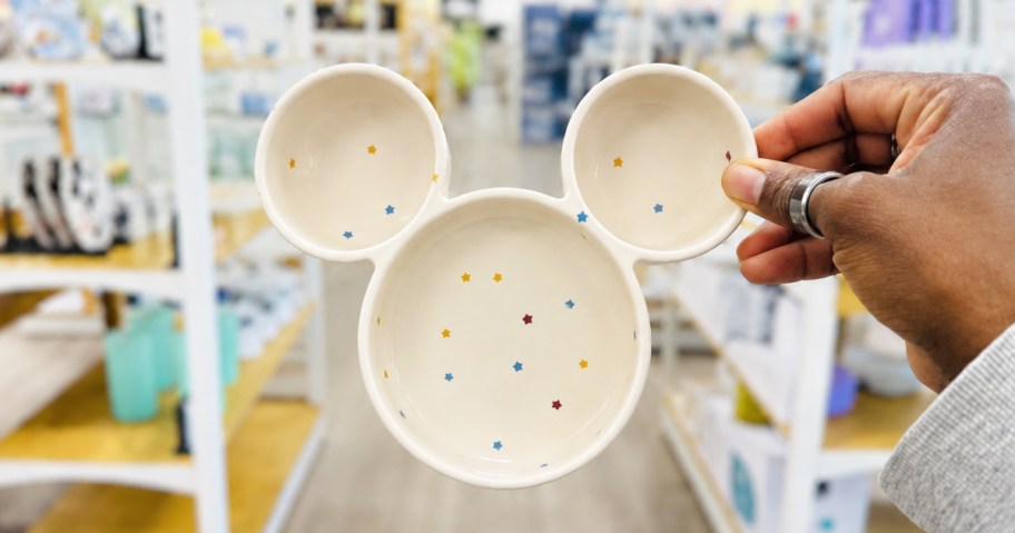 hand holding up a white mickey mouse head dish in store
