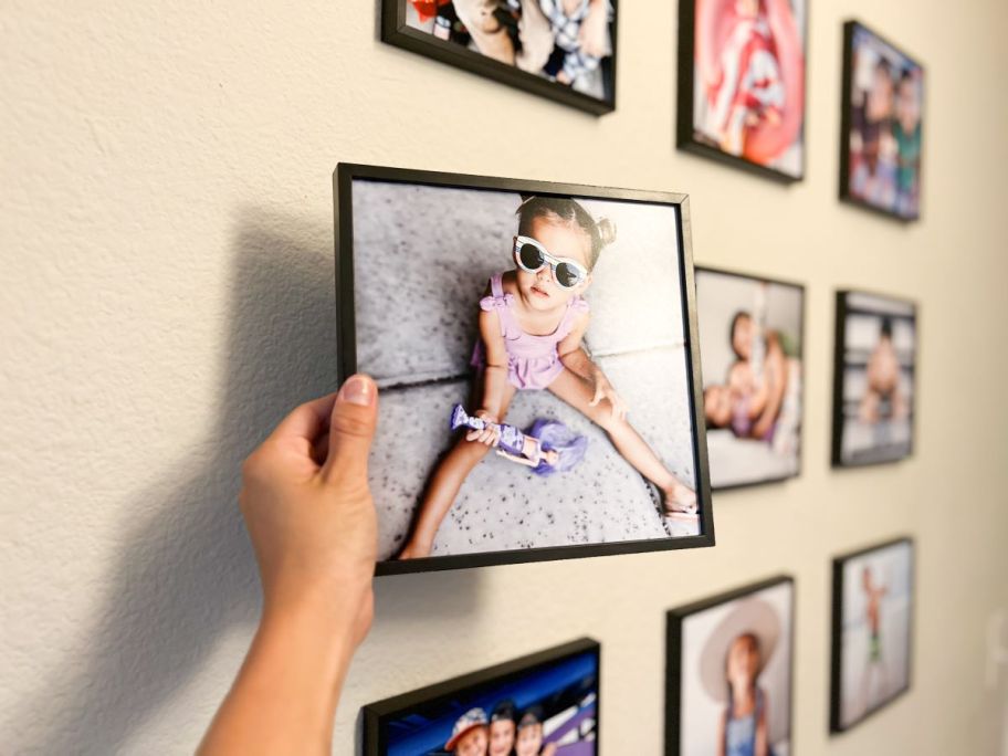 Hand holding a Tilepix photo of a little girl