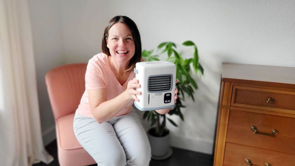 Woman holding a mini air conditioner